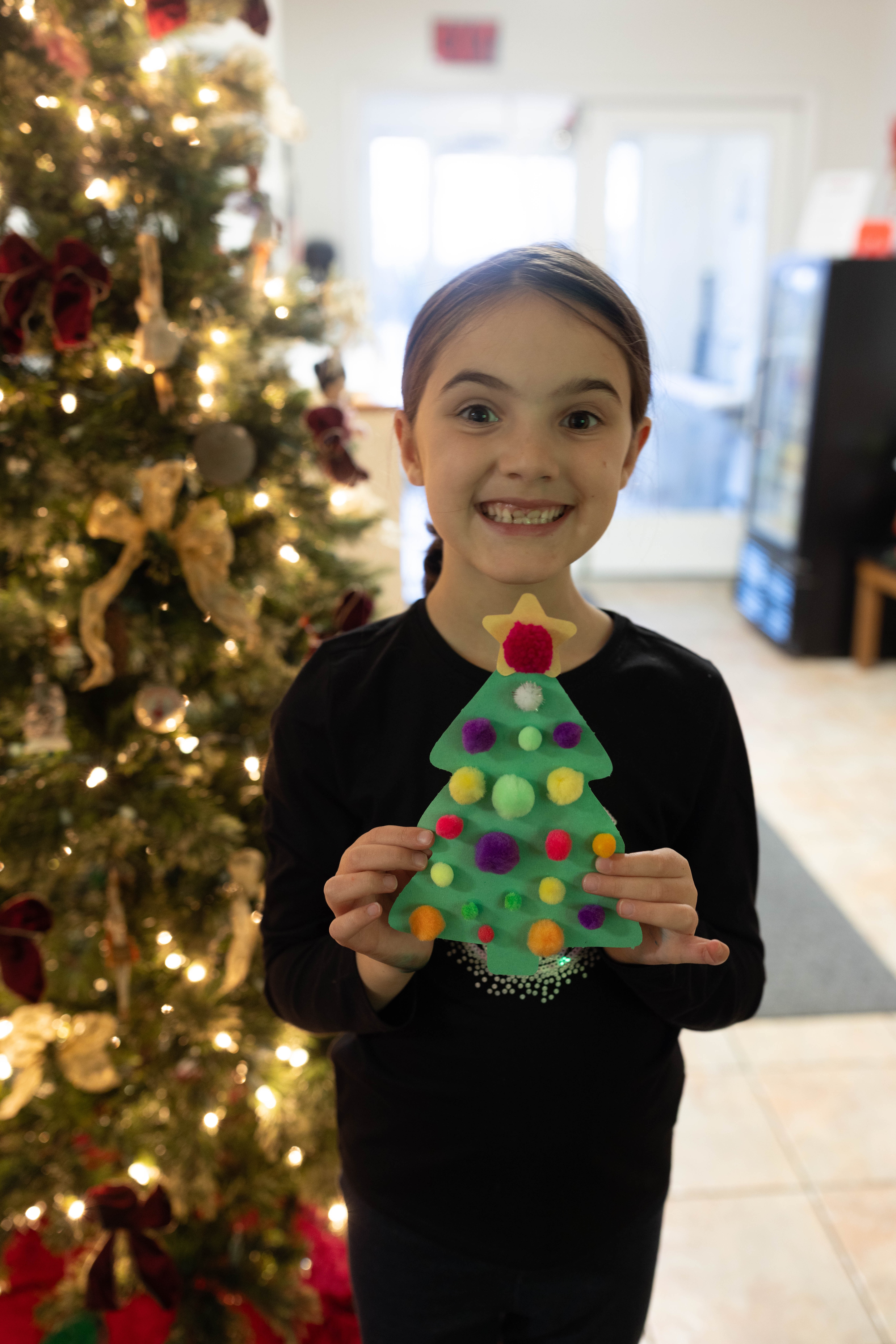 child with Christmas tree craft